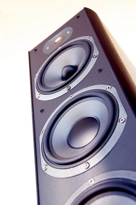 How does a speaker work to produce sound?